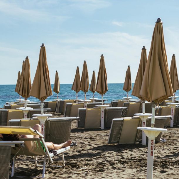 photograph of beach umbrellas on the sand