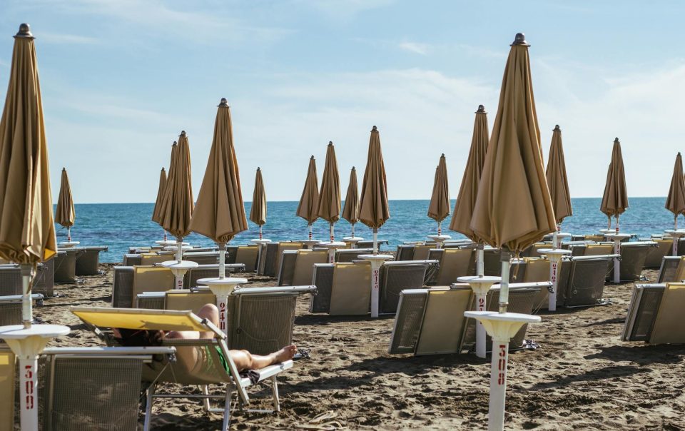 photograph of beach umbrellas on the sand